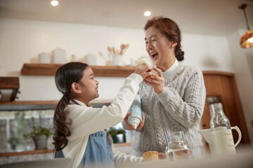 grandmother and granddaughter cooking time