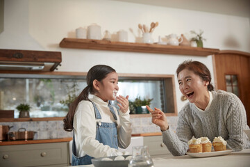 grandmother and granddaughter cooking time