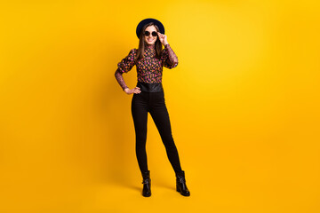 Fototapeta na wymiar Full length body size photo of girl wearing printed fashion clothes sunglass black headwear smiling isolated bright yellow color background