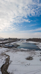Backwater on the river with a ship repair shop on the shore