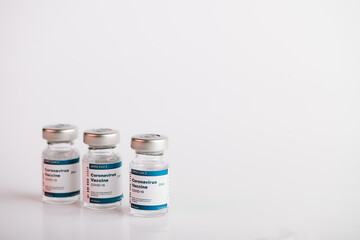 three Covid-19 vaccine vials with white background