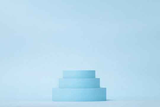 Beauty products background. Cylinders on blue. Podium stand, trendy minimal geometric scene © studiomay