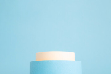Beauty products background. Beige and blue cylinders on background with copy space. Podium stand, trendy minimal geometric scene