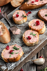 Pate spread on toasted bread with greens and pomegranate, Chicken liver pate spread. vertical image, place for text