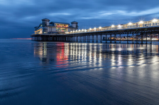 Fototapeta Long Exposure Image Of Weston-super-Mare Pier With Reflected Lights On The Wet Sand