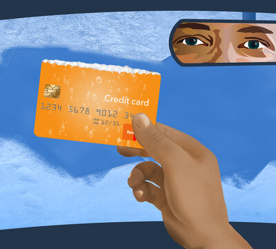 A Hand Holds A Credit Card That Was Used To Scrape Frost And Ice Off Of A Car Windshield. Illustrates How Useful Owning A Credit Card Can Be.