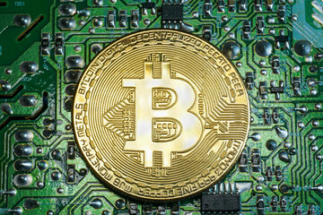 A Bitcoin on a printed circuit board. Bitcoin is a digital cryptocurrency that can be exchanged for other currencies, products or services.