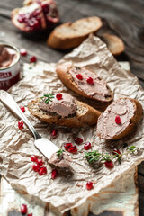 Fototapeta na wymiar Chicken homemade liver paste or pate with sliced whole grain bread. Top view, vertical image