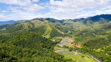 Naklejka na ściany i meble Beautiful mountain landscape on Luzon island, Philippines. Mountains and green hills in clear weather. Cordillera region, top view.