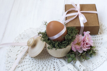 gift box, egg in a cup with moss, flowers. easter decor.