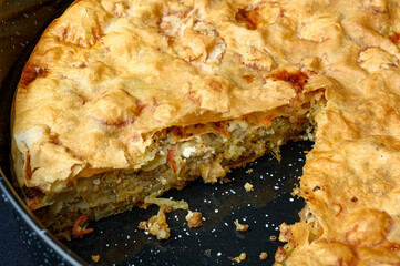 Delicious Greek Pontic-style homemade meat pie in black roasting pan