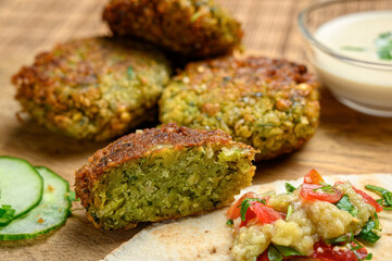 Homemade falafel served with pita bread, tomatoes, cucumber, lettuce, grilled aubergine salad and tahini sauce