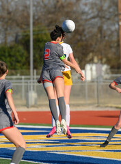 Young athletic girls competing in a soccer match