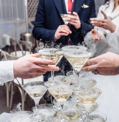 Pyramid of glasses with champagne close up.