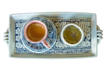 Top view of Espresso Shot and tea on ceramic plate, white isolated.