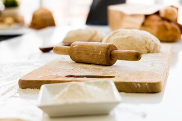 Rolling pin and Fresh dough on a Brown wooden slats background.