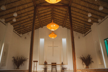 Rustic small church or chapel interior with cozy and welcoming light and decoration in Bahia, Brazil.