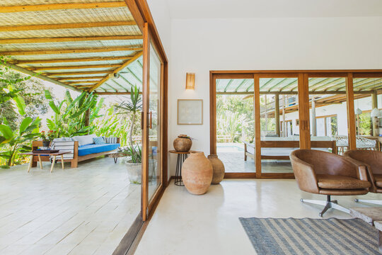 Modern summer holiday or vacation wooden beach house interior with rustic luxury sofas, tables and decoration. 