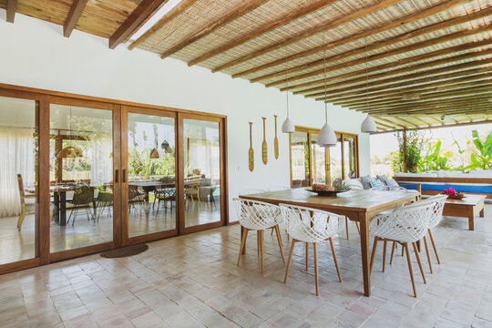 Modern summer holiday or vacation wooden beach house interior with rustic luxury sofas, tables and decoration. 