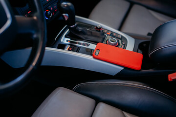Obraz na płótnie Canvas Smartphone on the modern car interior.