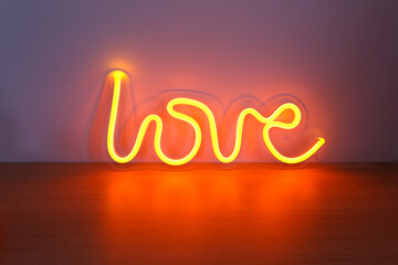 Neon sign orange love in the decor. Trendy style. Valentine day. Neon sign. Custom neon. Home...