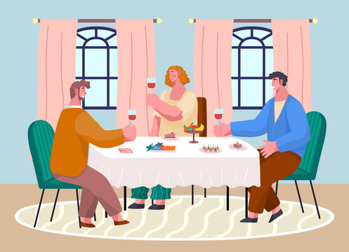 Happy people celebrating important event sitting at table near windows in restaurant, cafe or home. Woman and men holding glass with red wine talking. Fruits, canapes at table. Meeting at wine