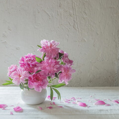 pink  peonies  on background old white wall