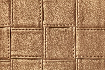 Texture of dark brown leather background with square pattern and stitch, macro.
