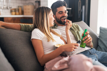 Happy couple eating popcorn