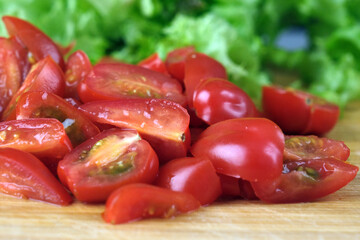 Sliced Tomato. Red tomatoes on a Wooden Cutting Board. Selective focus. Copy space. Top view