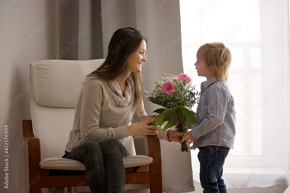 Sticker Beautiful blond boy, giving mother flowers and box with little gift for mothers day