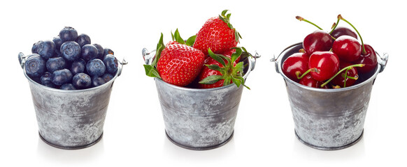 Various berries in metallic basket isolated on white