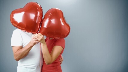 A cheerful mature couple in casual attire celebrates an event, Valentine's Day