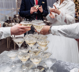 Pyramid of glasses with champagne close up.