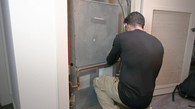 HVAC Technician Removing a Water Source Heat Pump Panel