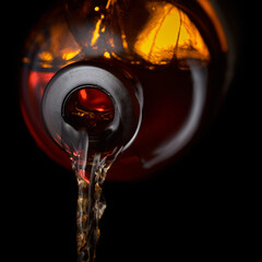 Whiskey is poured into a glass.