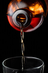 Whiskey is poured into a glass.