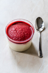 Delicious Italian Dessert Raspberry Panna Cotta with Berry Sauce.