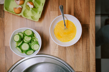 Preparing eggs for breakfast in home kitchen.