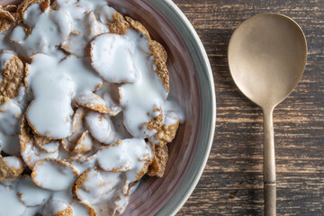 Whole grain glazed flakes with yogurt in plate. Healthy breakfast, whole grain muesli in a bowl