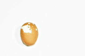 boiled egg cracked shell out on white background