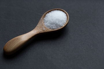 spoonful of salt on background