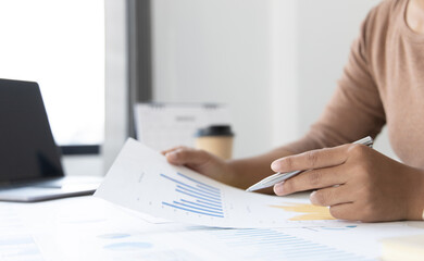 Financial businesswoman analyze the graph of the company's performance to create profits and growth, Market research reports and income statistics, Financial and Accounting concept.