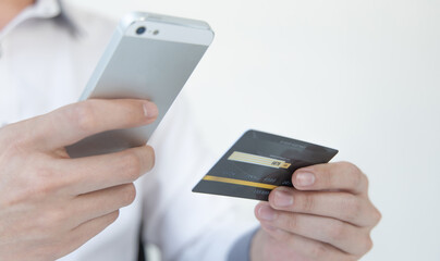 Businessman use mobile phones to register for security Online with a credit card to buy products online through application, Online shopping or Internet technology concept.
