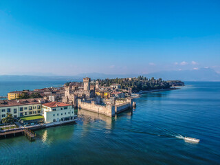 Fototapeta na wymiar View by Drone - Castle Rocca Scaligera in Sirmione, Garda Lake. spectacular view on lake, italian summer view aerial by Drone
