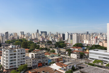 Fototapeta na wymiar Beautiful view of São Paulo city skyline, avenues, houses and downtown business buildings in the background on sunny summer day with blue sky. Concept of urban, travel, latin america, tourism.