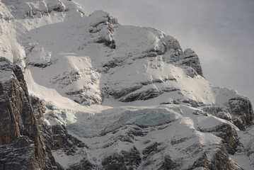 Obraz premium View of the Swiss mountains in winter. Mittelhornin clouds, Schreckhorn and Wetterhorn. Swiss alps in Switzerland Jungfrauregion