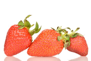 A group of many juicy strawberries, close-up, on a white background.
