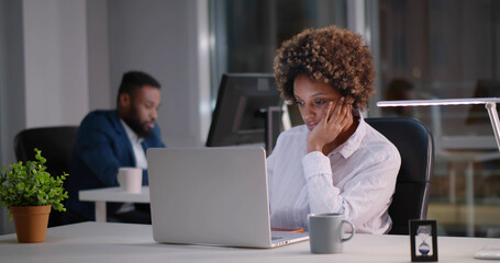 Tired business people submitting business report working late hours in office