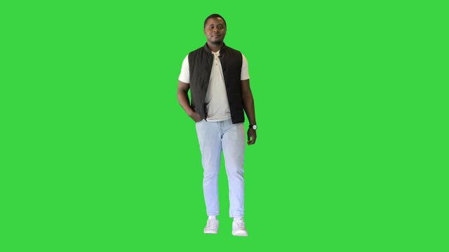 Casual African American man walking on a Green Screen, Chroma Key.